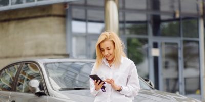 business woman using the smart phone outside office center