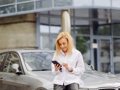 business woman using the smart phone outside office center