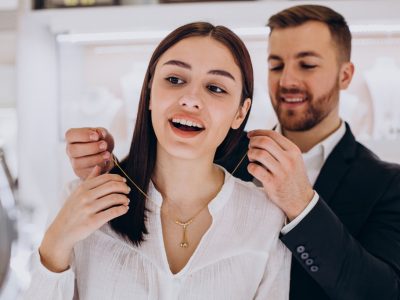 young couple choosing a necklace at jewelry store